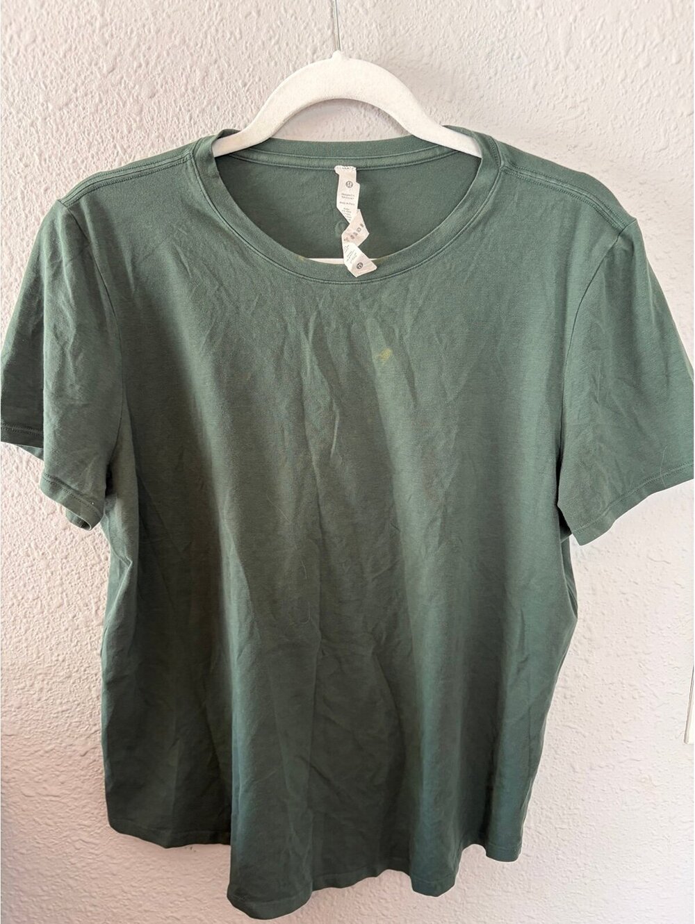 Lululemon green tee size 10. Bleach staining